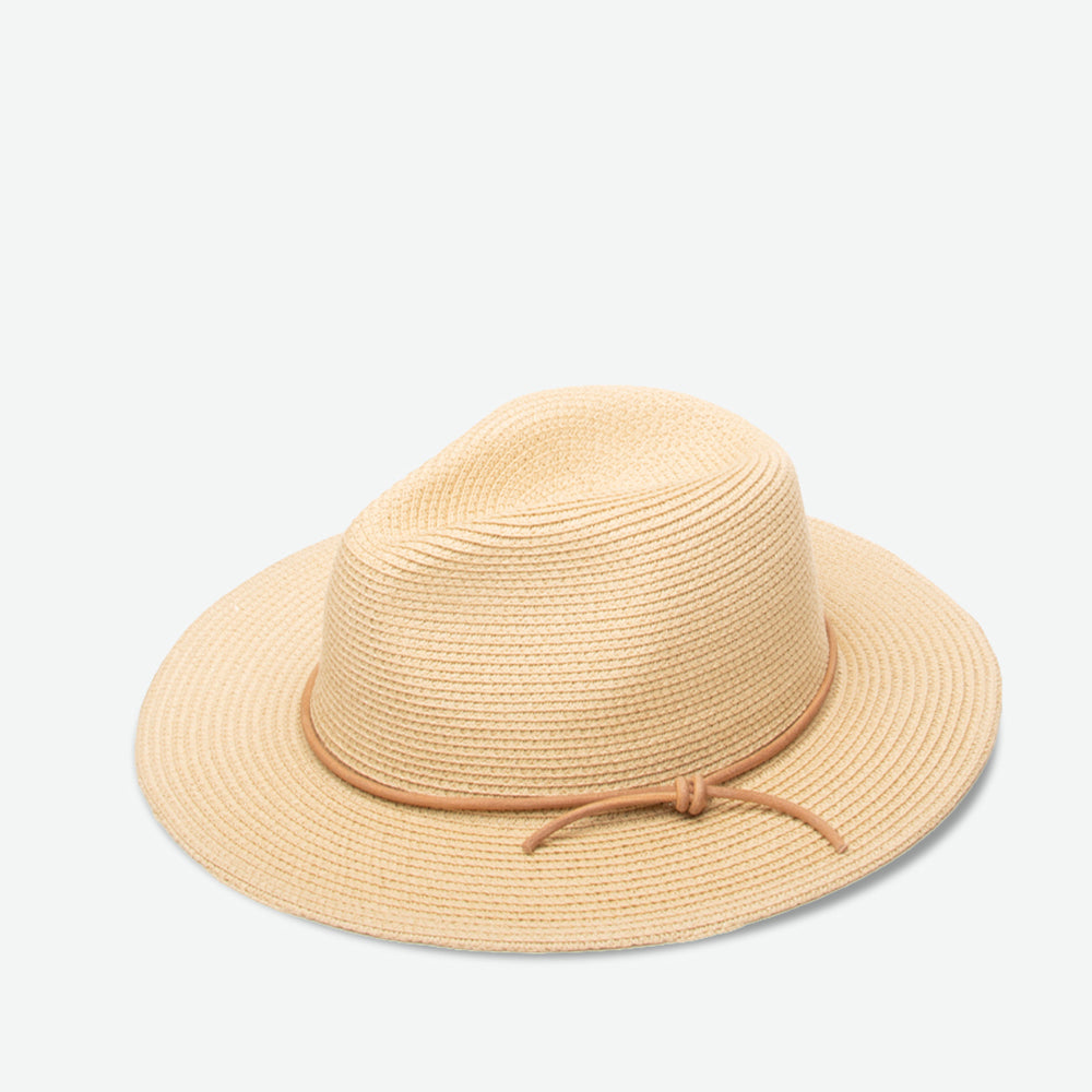 Beige straw hat with a tie on a light beige background