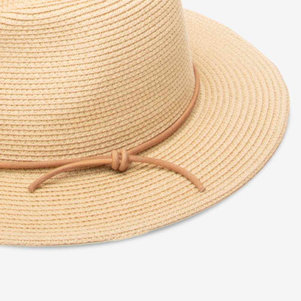 Beige straw hat with a brown ribbon on a light gray background