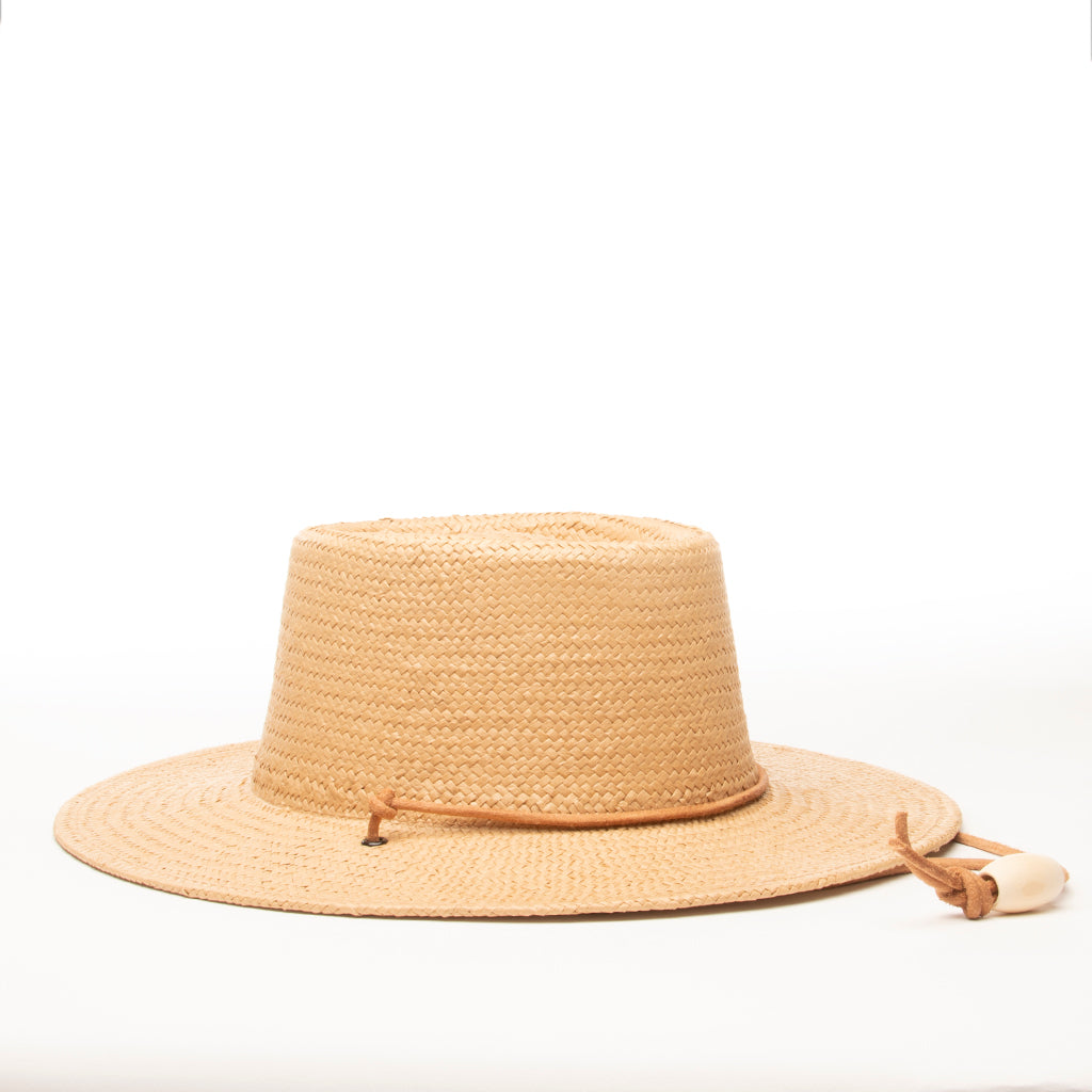 Boater hat made from 100% paper straw trimmed with a leather cord chin strap and adjustable wood bead.